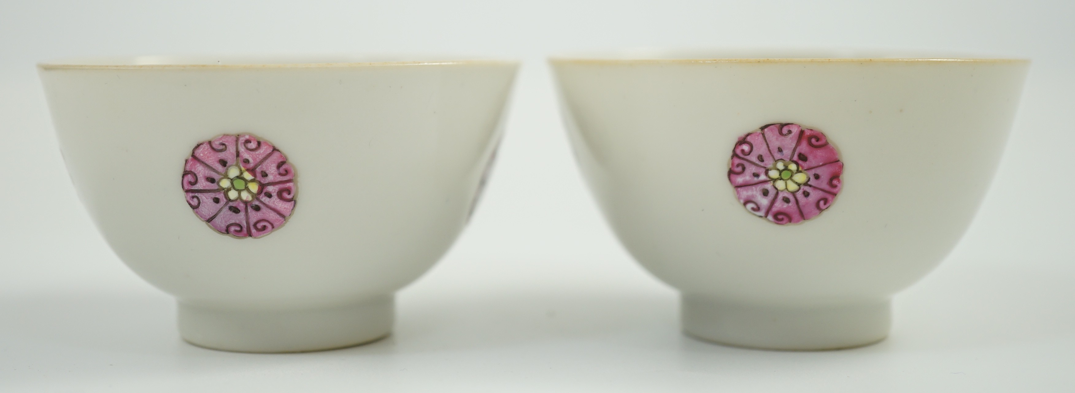 A pair of Chinese enamelled porcelain tea bowls, Qianlong seal marks, 7cms diameter